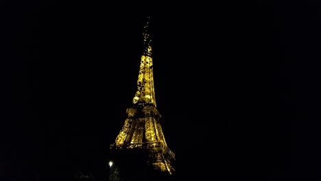 Golden-Eiffel-Tower-At-Night-In-Paris,-France---low-angle