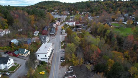 Aerial-View-of-Lake-Sunapee-Neighborhood,-Colorful-Autumn-Foliage,-Buildings-and-Road,-Drone-Shot