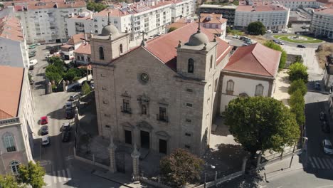 Aerial-orbiting-São-Miguel-Church-Facade,-Downtown-Castelo-Branco-City---Portugal