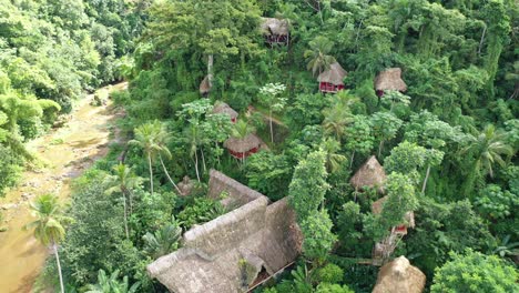 Aerial-top-down-backward-over-El-Valle-Tree-House-Village,-Samana