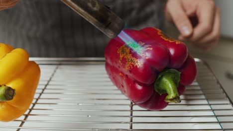 Torching-surface-of-red-pepper-with-gas-torch