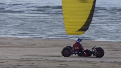 Kite-buggy-with-yellow-kite-on-the-beach-in-slow-motion-120fps
