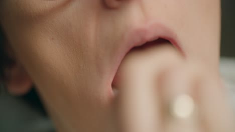 Close-up-shot-of-women-taking-a-swab-in-the-back-of-the-mouth-and-nose-carrying-out-a-Covid-19-rapid-antigen-self-home-test