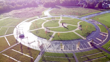 Modern-circular-cemetery-design-aerial-view-artistic-garden-of-rest-orbit-right-above-wet-shining-pathway