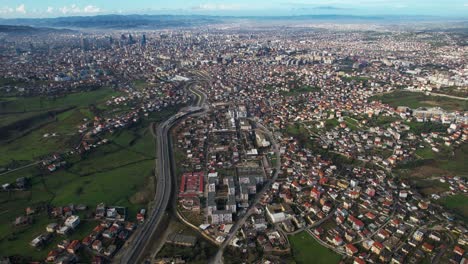 Suburb-and-industrial-area-near-Tirana-in-Albania,-wide-panoramic-view-of-capital-city