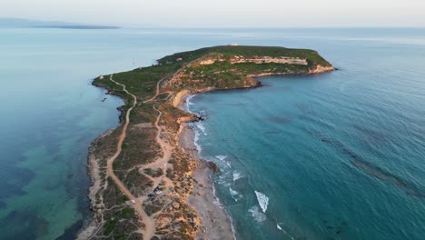 Capo-San-Marco-Beach-and-Peninsula-at-twilight-in-San-Giovanni-di-Sinis,-Sardinia---Aerial-4k