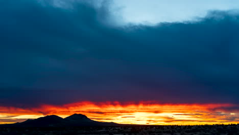 The-sun-rises-in-colorful-glory-over-the-Mojave-Desert's-rugged-terrain---static,-wide-angle-time-lapse