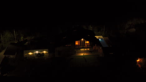 Single-family-home-with-a-pool,-night-footage-taken-with-drone
