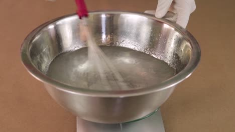 Mixing-chemical-ingredients-in-a-bowl-on-a-weighing-machine
