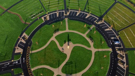 Modern-circular-cemetery-pathway-design-aerial-view-artistic-garden-of-rest-descending-tilt-up