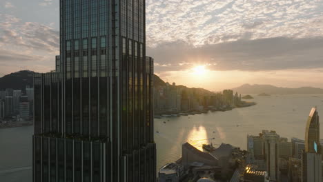 Cinematic-view-of-Rosewood-Hotel-facing-west-towards-Hong-Kong-Island-during-sunset