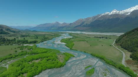 Rees-River-meandering-through-bottomlands-in-mountain-range,-New-Zealand