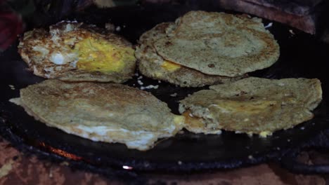 Frying-Newari-bara-with-eggs-and-meat-on-a-skillet-over-a-fire