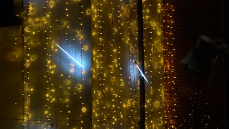 Dekorative-Blinkende-Lichter-Auf-Dem-Hintergrund-Der-Gebäudewand,-Kopierraum-Von-Gelben-Und-Neonflecken