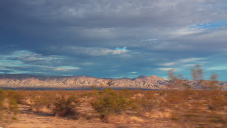 Driving-through-the-Mojave-Desert's-great-basin-on-a-calm-morning-with-a-colorful-sky