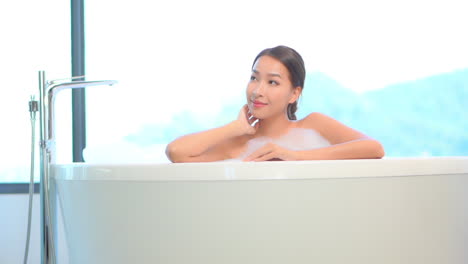 Beautiful-Asian-Woman-in-White-Bathtub,-Spa-Center,-Beauty-and-Makeup-Concept