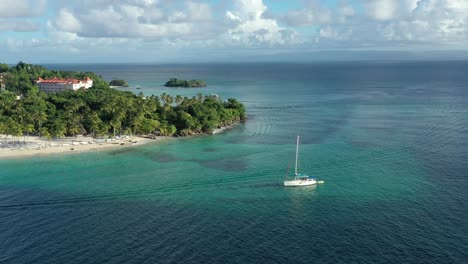 Tourists-on-board-of-luxurious-sailboat-anchored-in-transparent-sea-water-of-Cayo-Levantado
