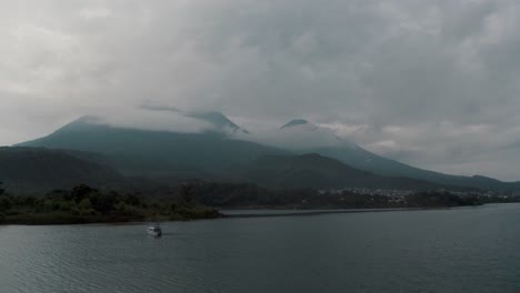 Passenger-Boat-On-The-Scenic-Lake-Atitlan-In-Guatemala-During-Sunrise---aerial-orbit