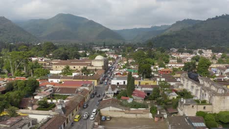 Rising-over-the-cityscape-of-Antigua,-sunny-day-in-Guatemala---Aerial-view