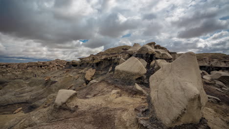 Bisti-Badlands-Wilderness-Time-Lapse,-Forming-Shapes-of-Clouds-Above-Dry-Desert-Landscape-and-Rock-Formations,-Full-Frame