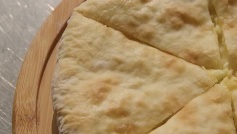 Fresh-Baked-Cheese-filled-Georgian-Flatbread-Khachapuri-Imeruli-,-closeup