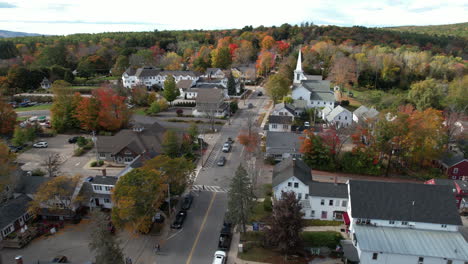 Aerial-View-of-Wolfeboro-Town,-Main-Street,-Houses,-First-Christian-Church,-Fall-Foliage-and-Traffic,-Drone-Shot