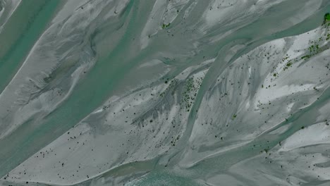 Rees-river-delta-with-slow-flowing-glacial-water-through-floodplain,-serpentine-shape,-top-down