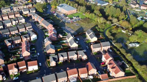 Aerial-view-above-new-build-modern-housing-estate-property-rooftops-England-zoom-out