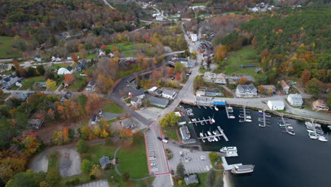 Sunapee-Town,-New-Hampshire-USA,-Aerial-View-of-Lakefront,-Harbor-and-Colorful-Autumn-Foliage,-Drone-Shot
