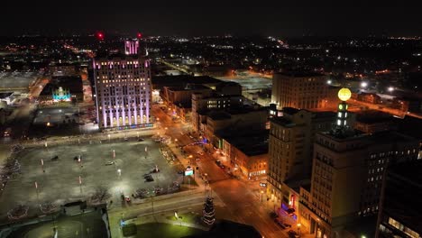 Flint,-Michigan-at-night-skyline-with-a-wide-shot-of-drone-video-circling