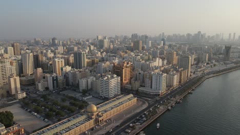 4K:-Aerial-view-of-Sharjah's-old-town-with-city-skyline,-residential-towers-in-the-United-Arab-Emirates