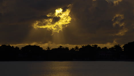 Golden-Sun-Streams-Down-From-Hole-In-Clouds-Onto-Water-In-South-Florida-Early-Morning