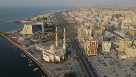 Drone-view-of-the-old-town-of-Sharjah-city,-Sharjah-port,-traditional-housed-and-a-mosque-in-the-United-Arab-Emirates