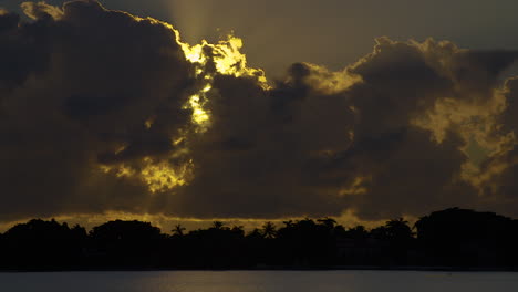 Dramatic-Sunrise-Behind-Dark-Clouds-With-Silhouetted-Trees-In-South-Florida,-U