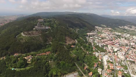 Viana-Do-Castelo-cityscape-with-Basilica-Santa-Luzia-on-hilltop,-aerial-drone-shot