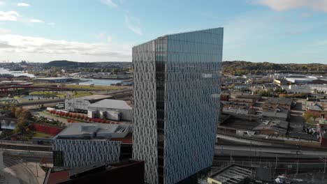 Aerial-parallax-motion-Modern-Gamlestaden-Travel-Centre-Building,-Old-City-Gothenburg