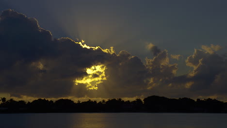 Sun-Rays-Stream-Out-From-Behind-Clouds-Into-Sky-In-South-Florida,-U