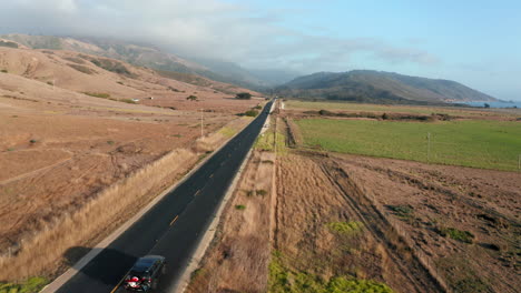 SUV-Car-Driving-Through-Empty-Asphalt-Coastal-Road-In-California