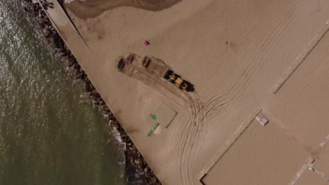 Excavator-picking-sand-from-beach,-Mar-del-Plata-in-Argentina