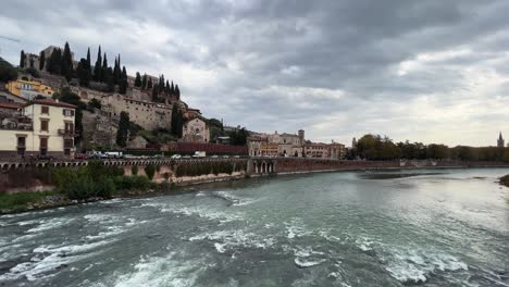 Wide-panoramic-view-of-Verona-old-town-cityscape-from-Adige-river-on-cloudy-day
