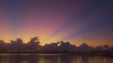 Pre-Dawn-Sunrays-Shooting-Out-From-Behind-Clouds-In-South-Florida,-U