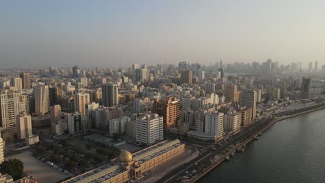 4K:-Aerial-view-of-Sharjah's-old-town-with-city-skyline,-residential-towers-in-the-United-Arab-Emirates