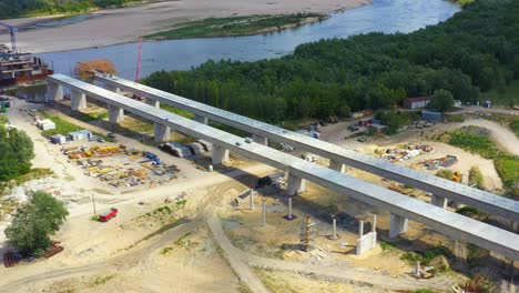 Aerial-shot-passing-over-a-bridge-construction-project-at-sunset-in-Vistula-near-Warsaw