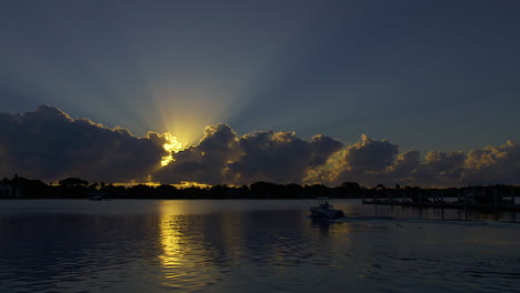 Small-Motor-Boat-Leaves-From-Dock-At-Sunrise-In-South-Florida,-U