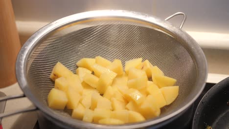 Chopped-Peeled-Potatoes-Steaming-In-A-Pot-With-Colander