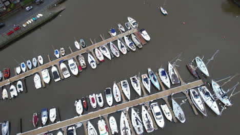 Birdseye-Aerial-View-of-Sailing-Boats-and-Motorboats-Moored-at-Docks-of-Kinsale-Marina-and-Harbor,-Republic-or-Ireland,-Drone-Shot