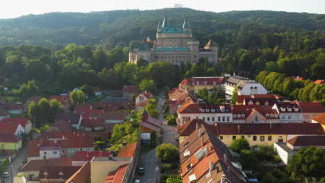Drone-shot-flying-over-the-town-in-front-of-the-Castle-Of-Spirits-or-Bojnice-Castle-in-Slovakia
