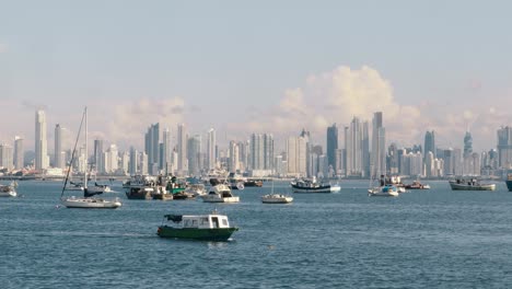 Panoramic-view-overlooking-the-boats-moored-in-the-Panama-Canal-marina,-in-the-distance-a-scenic-backdrop-of-the-spectacular-modern-buildings-and-beautiful-cityscape-of-Panama-City