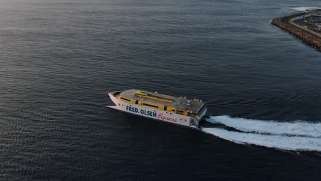 Fantastic-aerial-shot-of-a-ferry-leaving-the-port-of-Agaete-towards-Tenerife-during-sunset