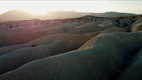 Drone-shot-of-an-adventurer-walking-through-the-Mahoya-desert-at-sunrise